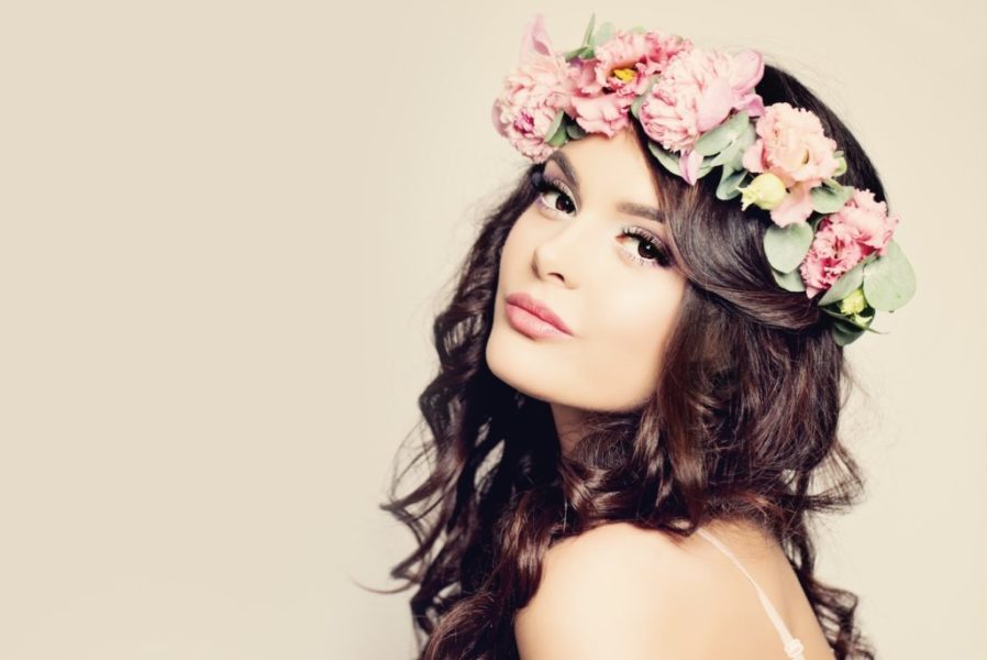 Beautiful Woman with Curly Hair, Makeup and Flowers Wreath